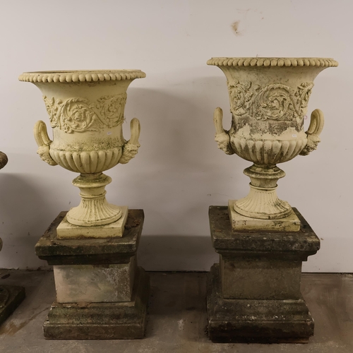 3001 - An pair of antique painted cast iron Medici style garden urns, with two handles and foliate decorati... 