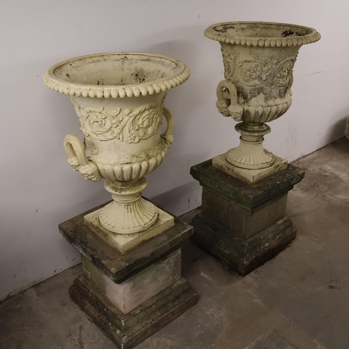 3001 - An pair of antique painted cast iron Medici style garden urns, with two handles and foliate decorati... 