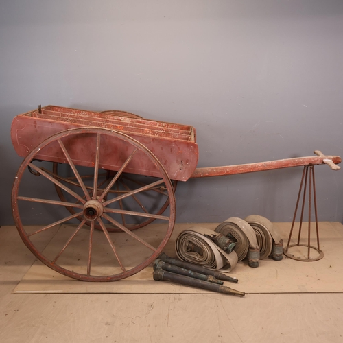 3011 - An antique fire cart, acquired by the vendor from Bayham Abbey, with three fire hoses and nozzles. O... 