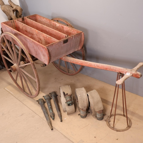 3011 - An antique fire cart, acquired by the vendor from Bayham Abbey, with three fire hoses and nozzles. O... 