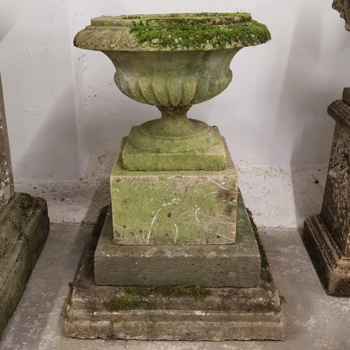 3013 - A weathered concrete two section garden urn on stepped pedestal plinth base in three sections. Overa... 
