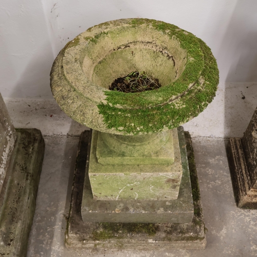 3013 - A weathered concrete two section garden urn on stepped pedestal plinth base in three sections. Overa... 