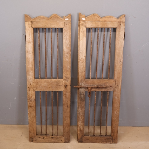 3269 - A pair of oak shutter doors with inset iron bars and bolt lock. Dimensions of each door: Width 40cm,... 