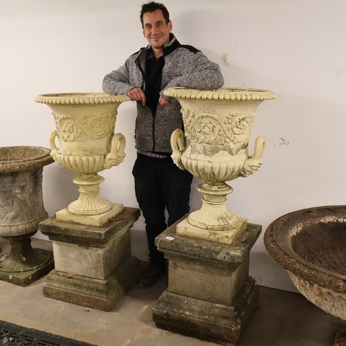 3001 - An pair of antique painted cast iron Medici style garden urns, with two handles and foliate decorati... 