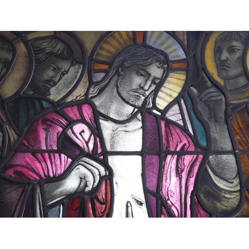 251 - A late 19th early 20th century stained glass religious window panel in the manner of Douglas Stracha... 