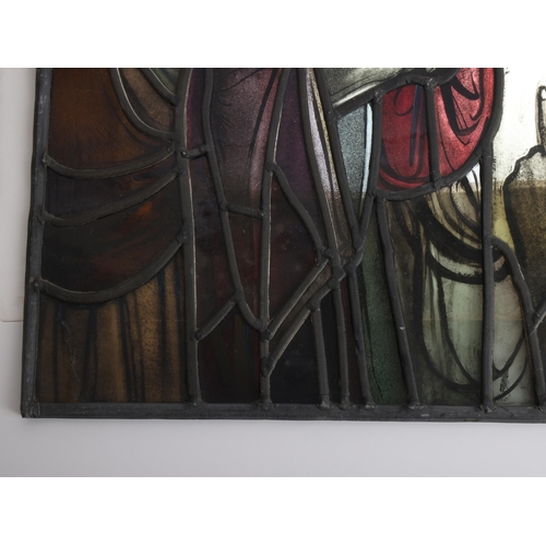 251 - A late 19th early 20th century stained glass religious window panel in the manner of Douglas Stracha... 