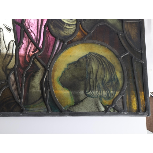 251 - A late 19th early 20th century stained glass religious window panel in the manner of Douglas Stracha... 