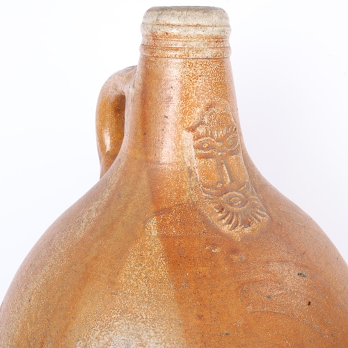 257 - A large salt glaze stoneware Bellarmine jug, 17th or 18th century, height 43cm, on a 19th century co... 