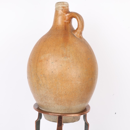 257 - A large salt glaze stoneware Bellarmine jug, 17th or 18th century, height 43cm, on a 19th century co... 