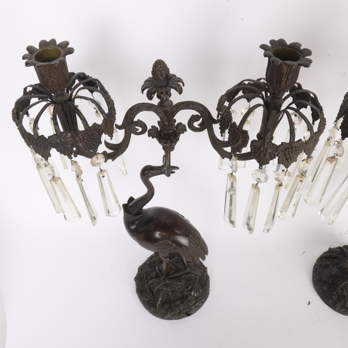 269 - A pair of Regency Period patinated bronze twin-branch candelabra, supported by cranes, with cut-glas... 