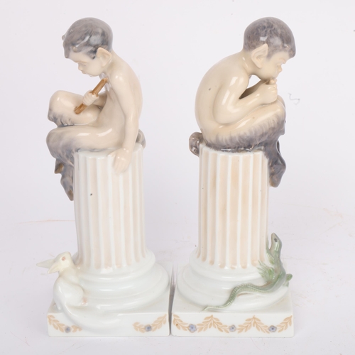298 - A pair of Royal Copenhagen figures of fauns sitting on a column, height 21cm