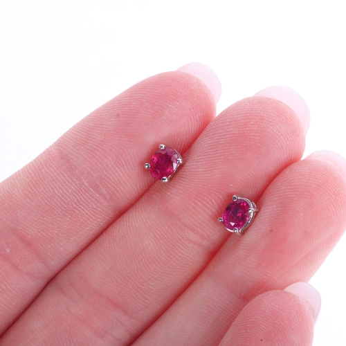 A matched pair of 18ct white gold single stone ruby stud earrings, each ...
