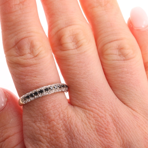 1195 - A 9ct gold black diamond and diamond half eternity band ring, pave set with modern round brilliant-c... 