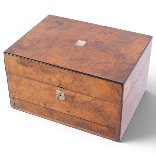 44 - A Victorian walnut travelling toilet case, the interior fitted with original glass jars with plated ... 