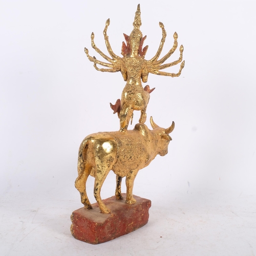 A Thai gilt-bronze figure of Shiva riding a bull, height 43cm