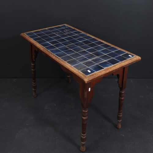 2113 - A Victorian Arts and Crafts mahogany-framed side table, with inset blue glazed tile top, 99cm x 53cm... 