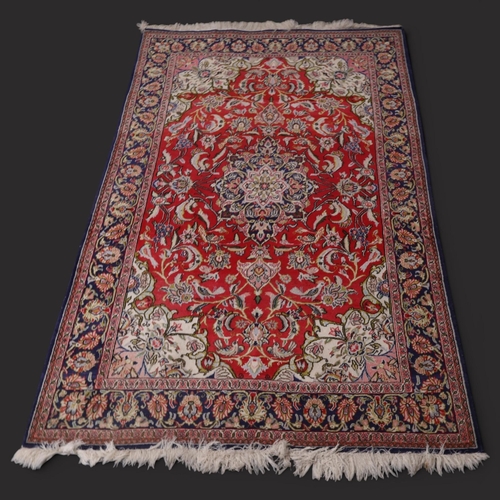 A red and blue-ground Persian rug with floral design. L219cm, L129cm.