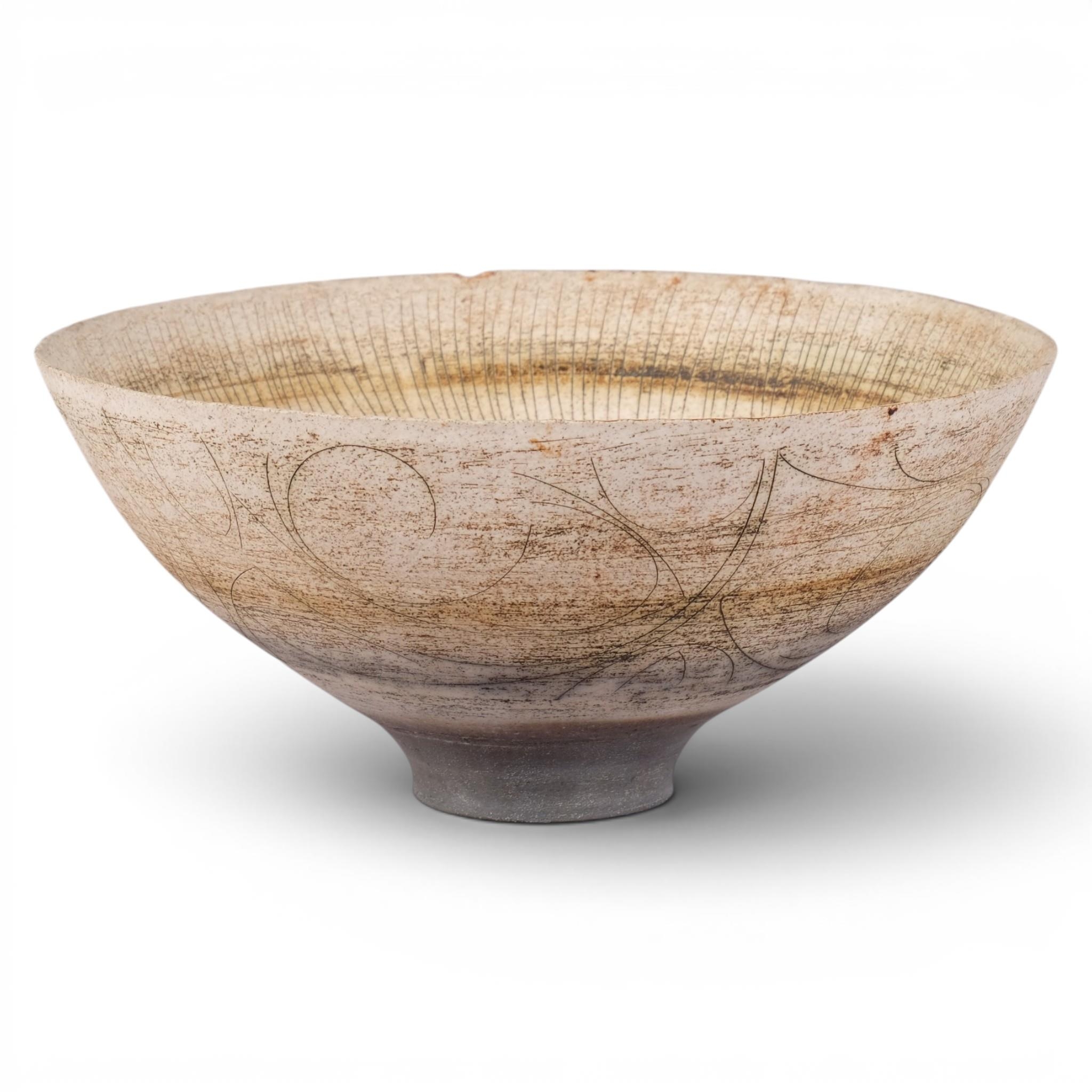 A large stoneware studio pottery bowl, footed with flared rim and ...