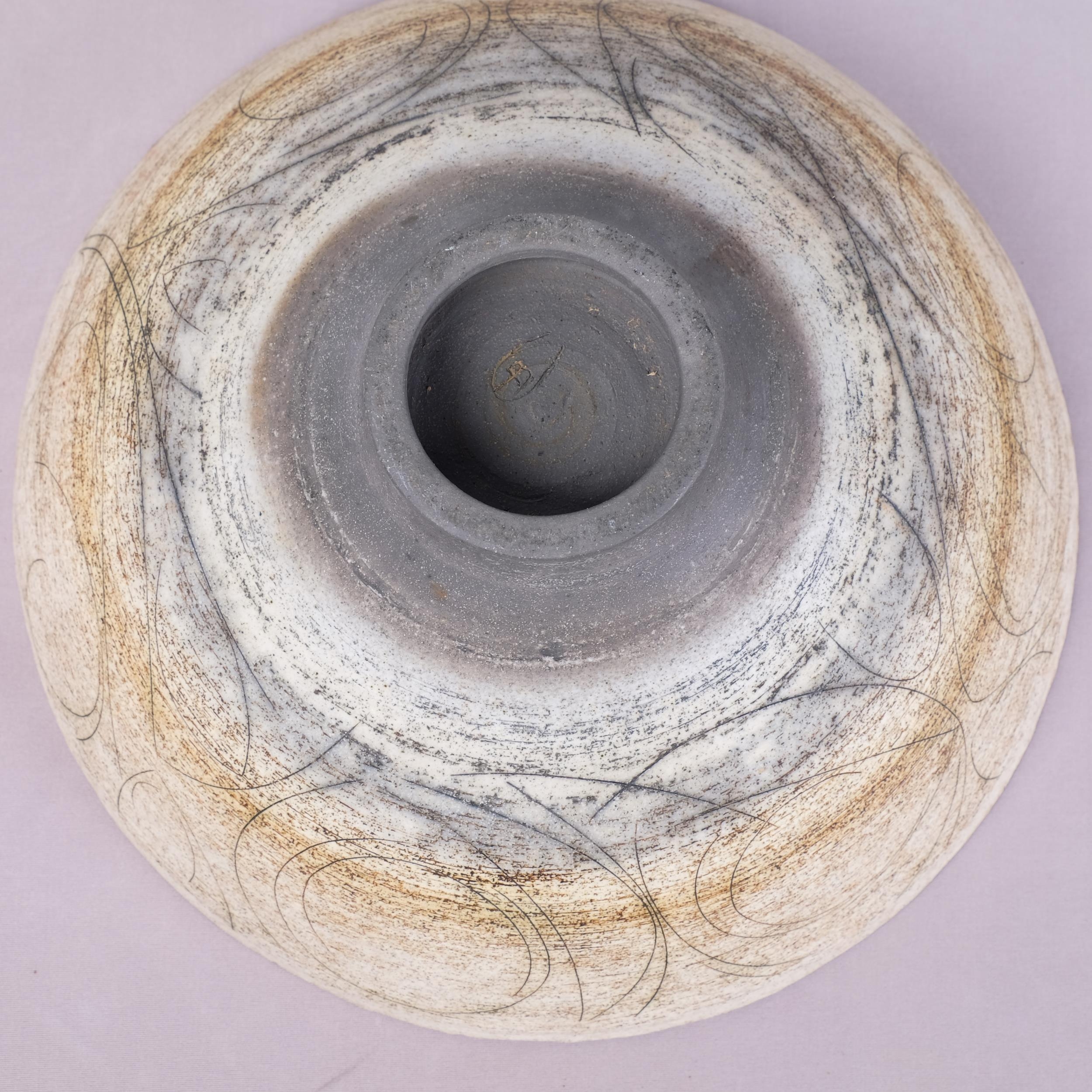 A large stoneware studio pottery bowl, footed with flared rim and ...