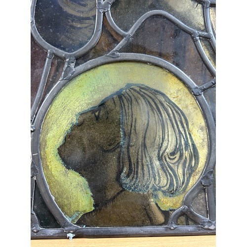 251 - A late 19th early 20th century stained glass religious window panel in the manner of Douglas Stracha... 