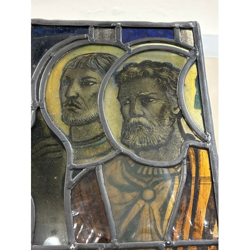 251 - A late 19th early 20th century stained glass religious window panel in the manner of Douglas Stracha... 