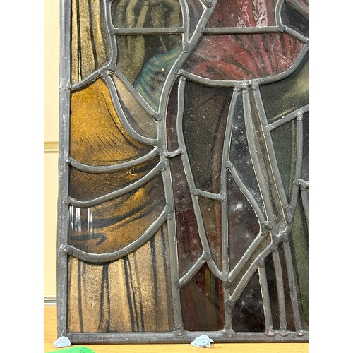 251 - A late 19th early 20th century stained glass religious window panel in the manner of Douglas Stracha... 