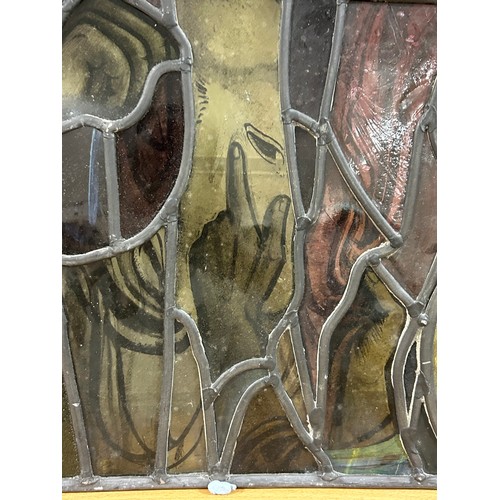 251 - A late 19th early 20th century stained glass religious window panel in the manner of Douglas Stracha... 