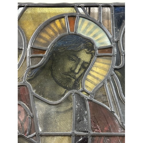 251 - A late 19th early 20th century stained glass religious window panel in the manner of Douglas Stracha... 