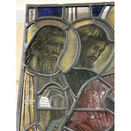 251 - A late 19th early 20th century stained glass religious window panel in the manner of Douglas Stracha... 