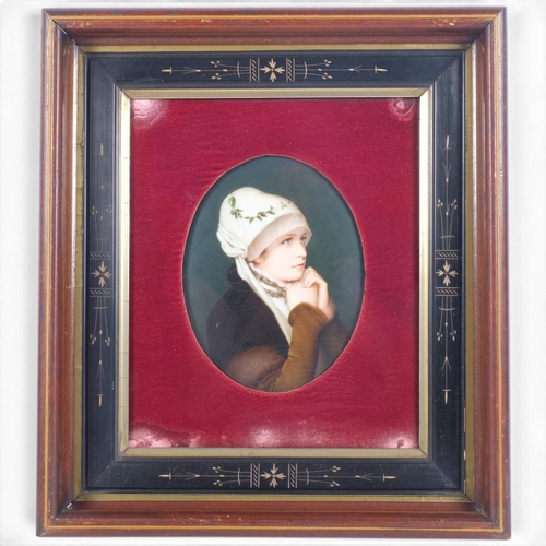 A finely painted 19th century German porcelain plaque, possibly KPM, portrait of a woman after Friedrich von Kaulbach, red velvet mount in original stained wood frame, no factory marks, plaque 21.5cm x 17cm, overall frame dimensions 43cm x 38cm