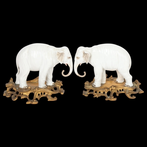 A fine pair of white glaze porcelain elephants, probably late 19th century Samson Paris, no factory marks, mounted on original ormolu stands, overall height 17.5cm