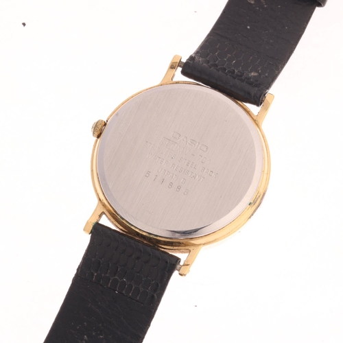 1014 - CASIO - a gold plated stainless steel Traddy Neo Classic quartz calendar wristwatch, silvered dial w... 