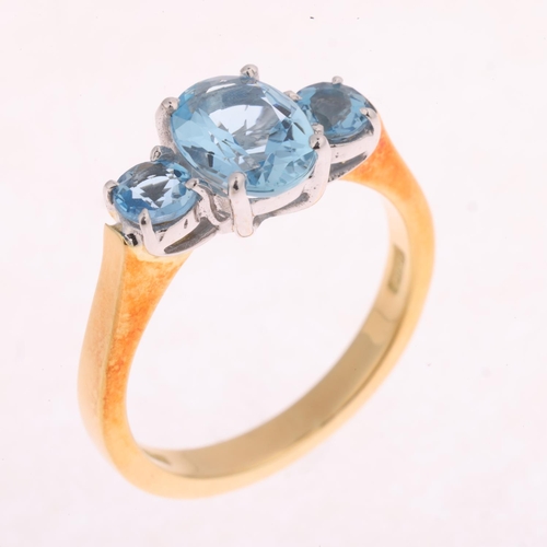 1122 - An 18ct gold three stone aquamarine ring, maker IDJC, London 1997, claw set with oval and round-cut ... 