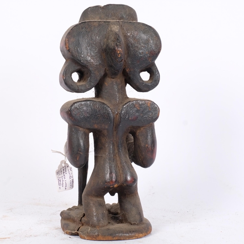 36 - An Antique African Chokwe carved wood figure of a man, early 20th century, H27cm