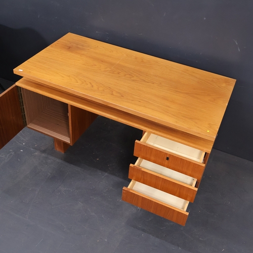 2020 - A Vintage Continental teak veneered kneehole writing desk. W130cm, H76cm, D65cm.