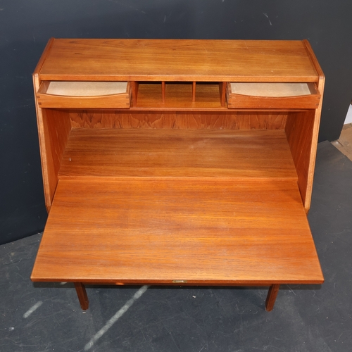 2028 - A Mid Century Danish teak veneered writing desk with writing slope, three exterior drawers and two i... 