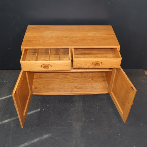 2029 - A contemporary Ercol Windsor cabinet in solid ash, with two drawers over two doors in light finish. ... 