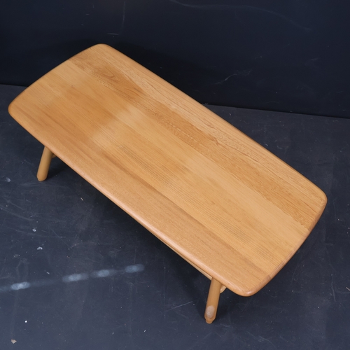 2033 - An Ercol Windsor coffee table in solid ash with magazine rack to underside in light finish. W105cm, ... 