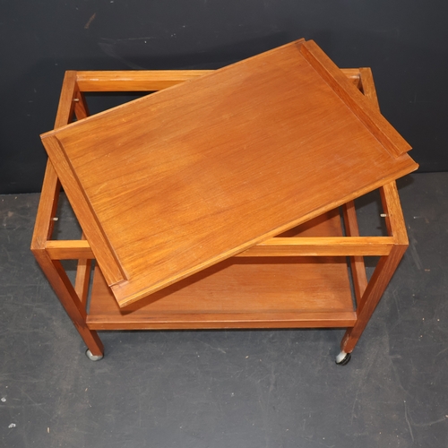 2049 - A vintage Danish two tier teak drinks trolley on castors with removable tray top labelled for BL Mob... 