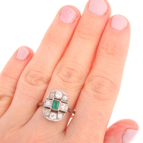 1106 - An Art Deco emerald and diamond cluster ring, the oval openwork panel set with 0.25ct octagonal step... 