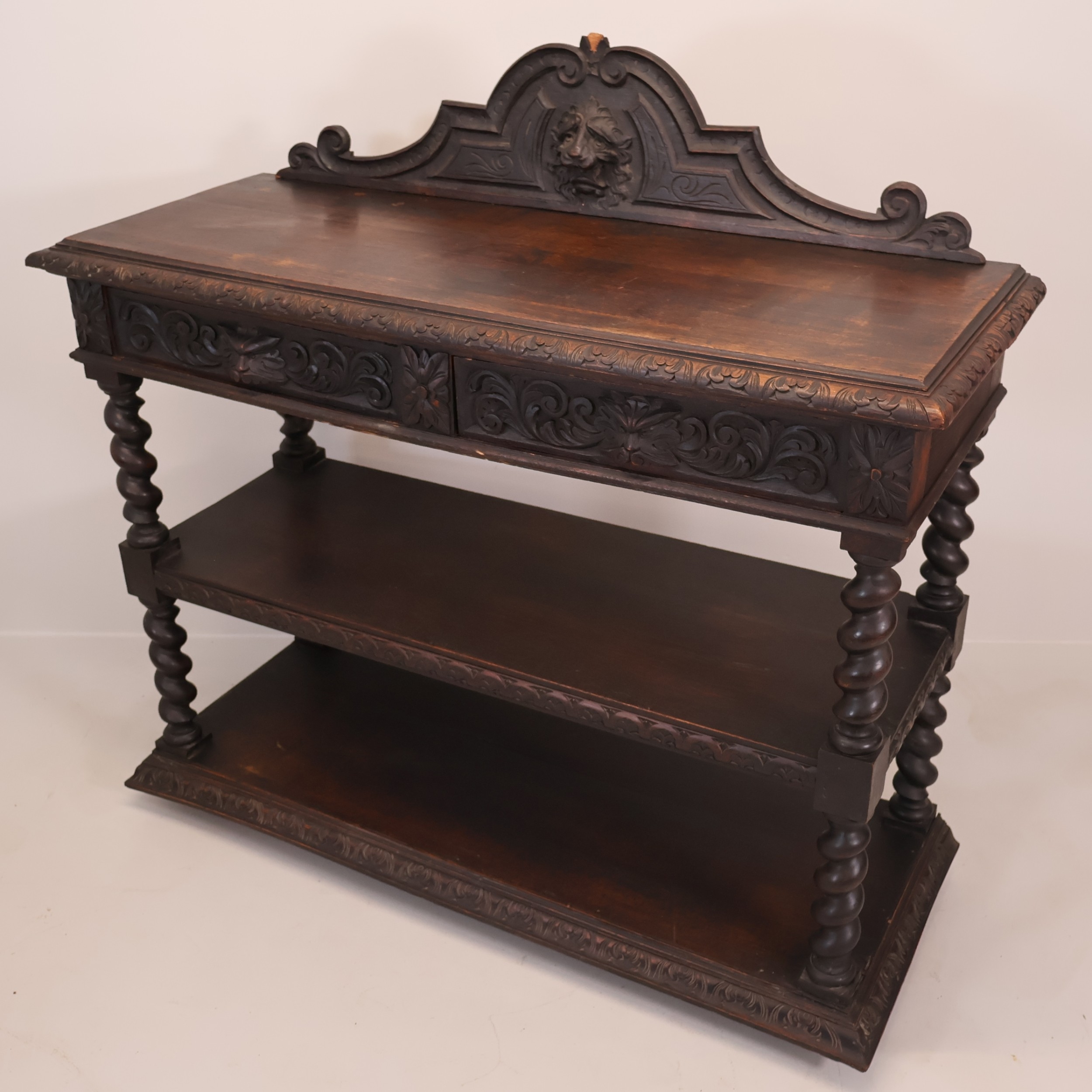 A Victorian oak three-tier buffet, with raised back, carved lion mask ...
