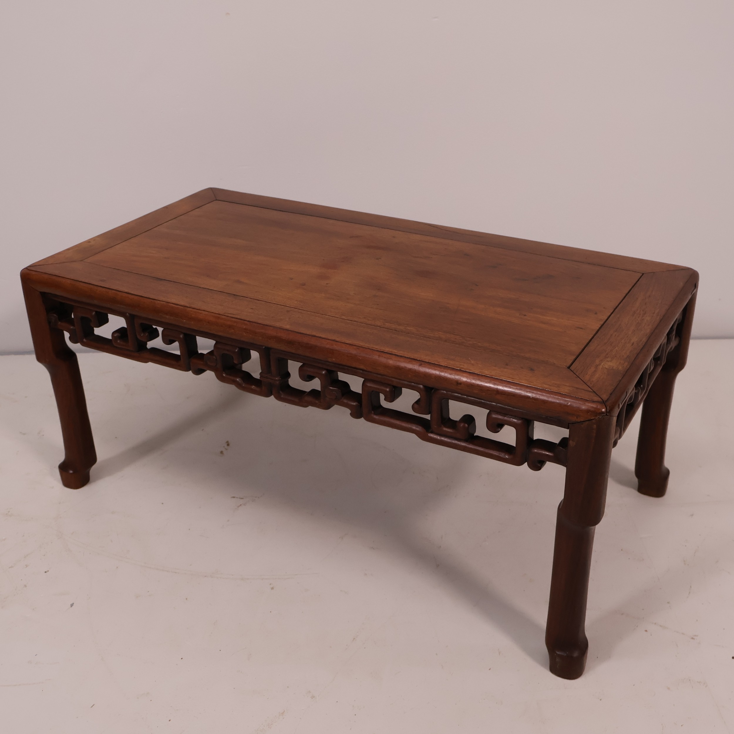 A Chinese hardwood rectangular coffee table with pierced decoration ...