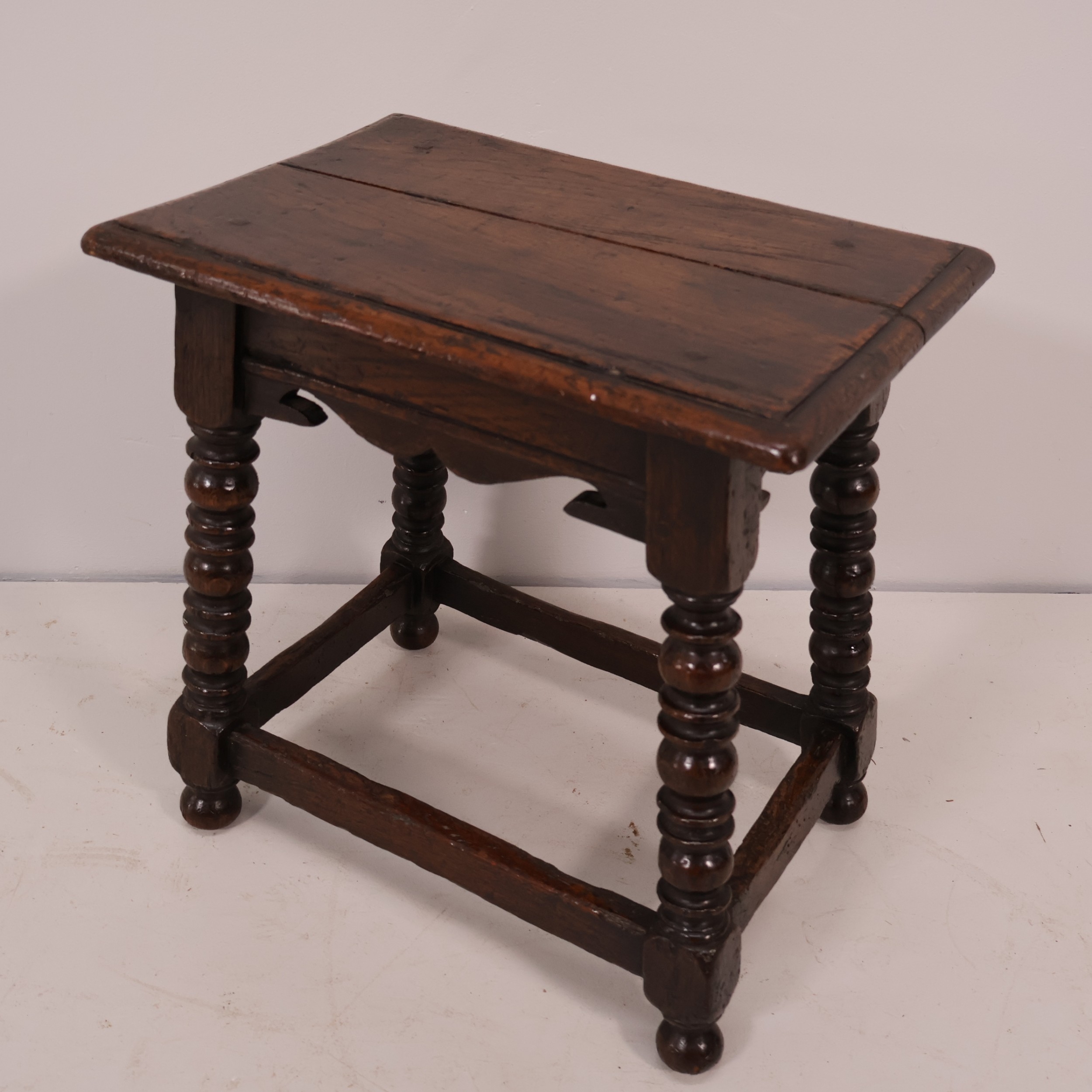 An antique oak joint stool, with turned supports and all-around ...