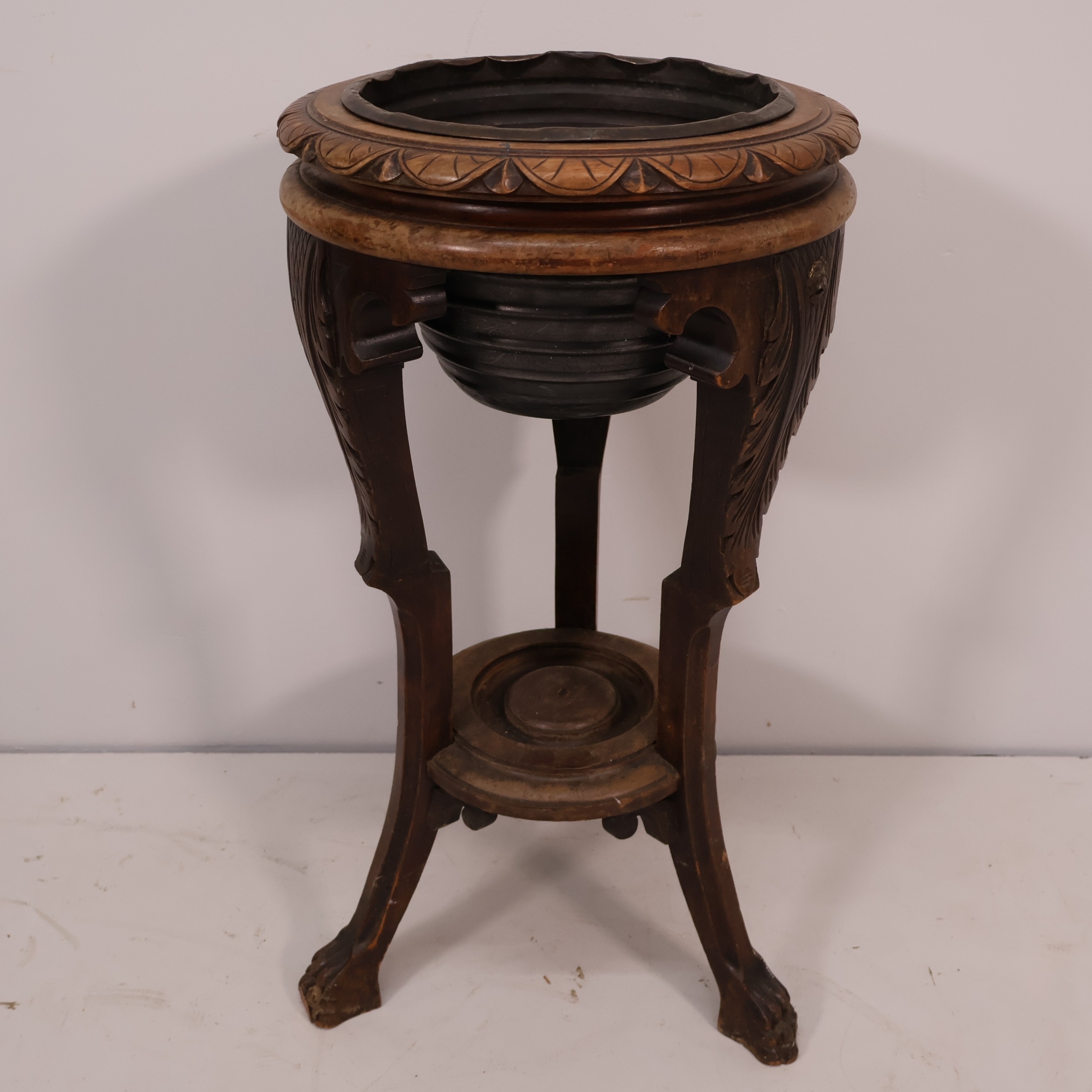 An early 20th century oak Jardiniere stand, with metal liner, cabriole ...