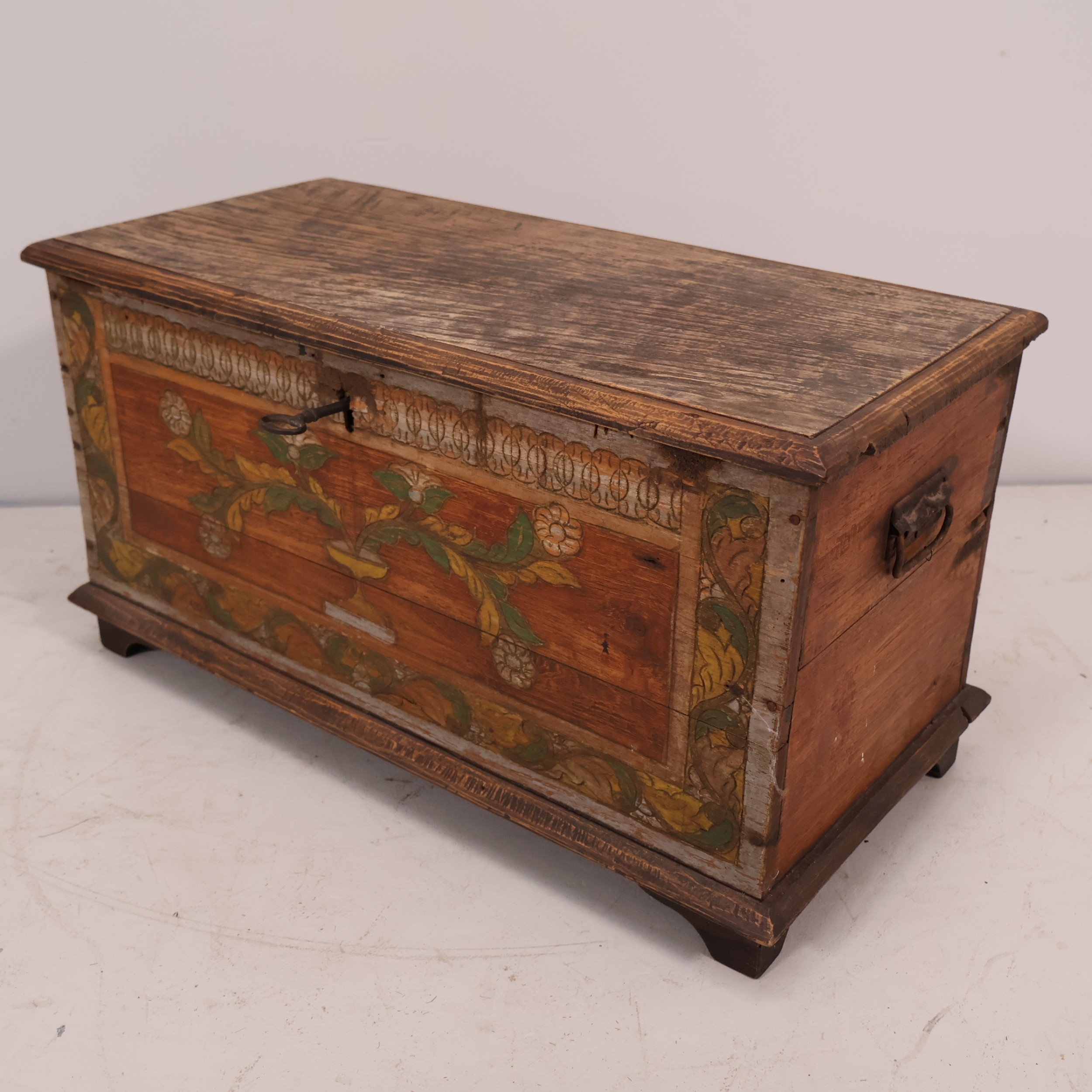 A small early 20th century oak chest, with carved and painted floral ...