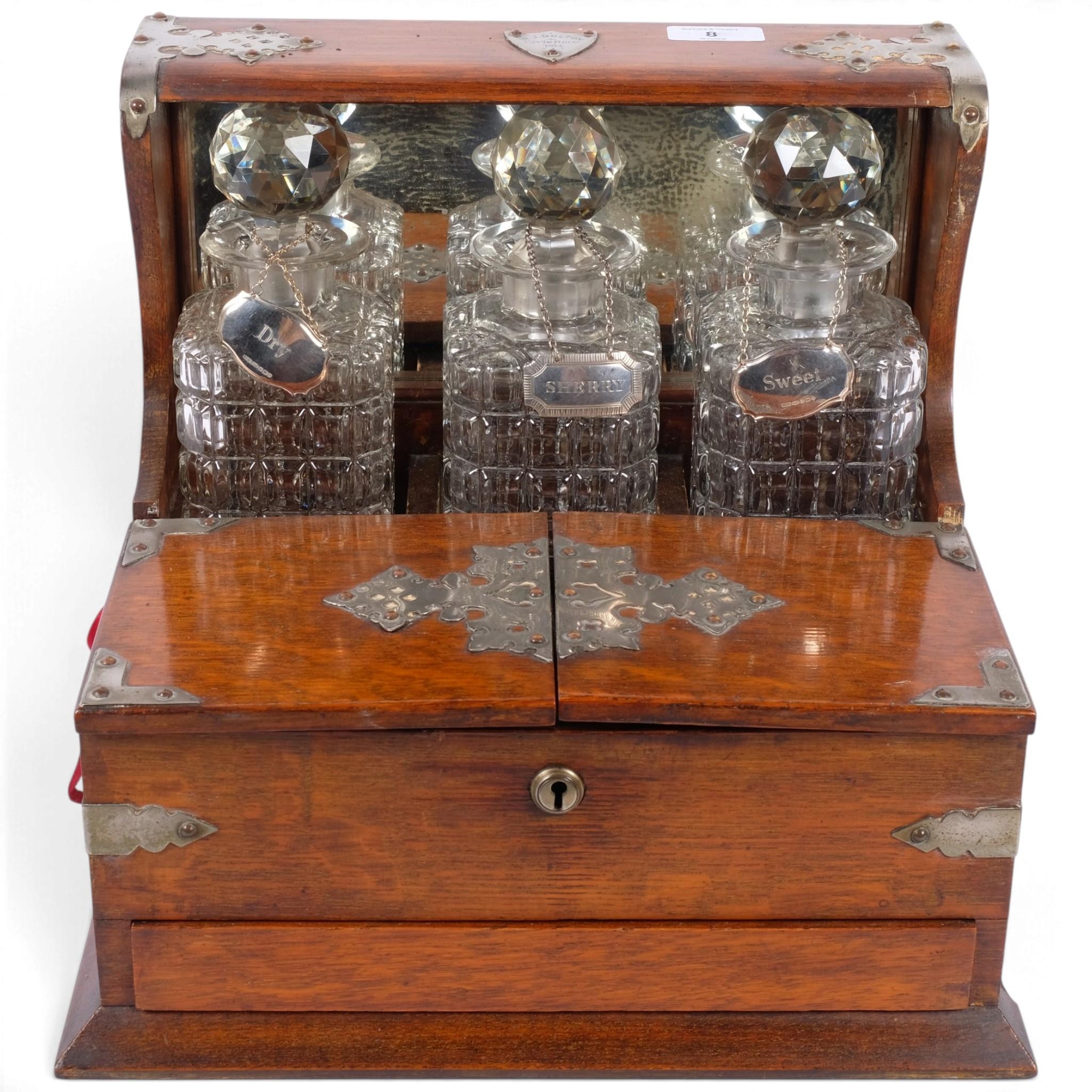 A late Victorian oak tantalus with integral cigar box front, hinged ...