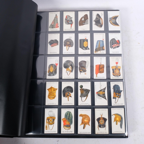A large album of cigarette cards, including complete sets, these issued ...