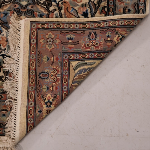 A blue-ground Persian floral design rug. L157cm, W98cm.