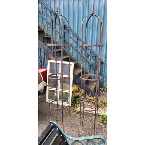 1 - A tall pair of wrought iron garden obelisks, each finished with an arched top and pointed finial