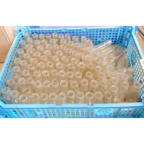 1026 - A crate containing a quantity of assorted small old glass bottles
